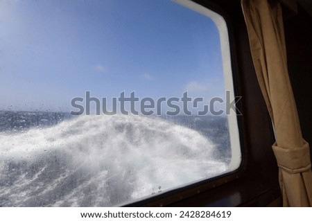 View from the cabin of the antarctic dream navigation in rough seas near cape horn, drake passage, antarctic ocean, south america