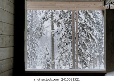 View from the cabin in the woods. Winter forest covered in snow. Nordic winter, in the forest during the snowfall. Background for stories about winter, Christmas, Nordic countries and snowfall - Powered by Shutterstock