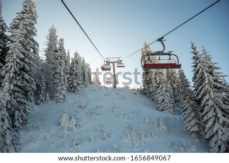 View from the cable car to the beautiful forest covered with snow. The mountain is a beautiful day into winter.