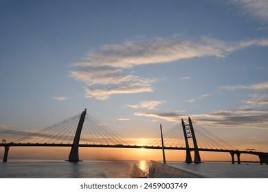 View of the cable-stayed bridge from a Soviet-made box. Meteor. Sunset bridge and clouds. Hydrofoil