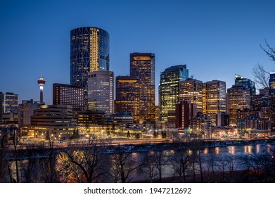 View of Calgary's skyline along the Bow River at dusk. 