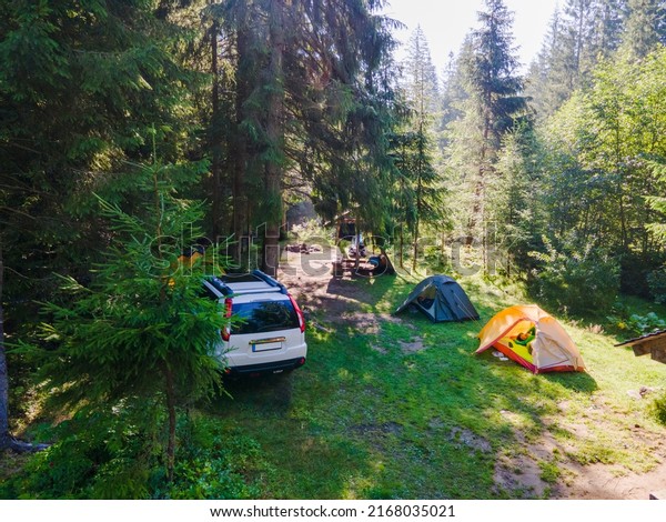view of\
camping site with tent and suv car copy\
space