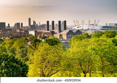 View of Canary Wharf and North Greenwich in east London surrounded by trees from Greenwich Park, London, England, United Kingdom