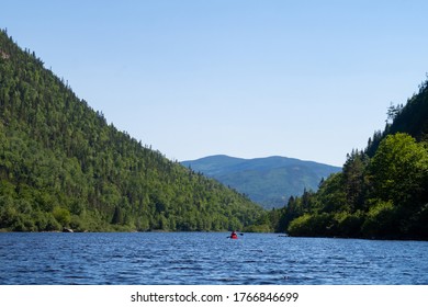 View Of A Canoe On The Malbaie River, In The Hautes-gorges-de-la-rivière-Malbaie National Park, Canada 