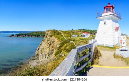 View of the Cape Enrage lighthouse, shoreline and cliffs, in New Brunswick, Canada - Shutterstock ID 1217184166