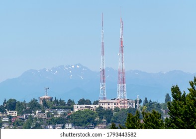 View from Capitol Hill in Seattle of the Olympic Mountains in West Washington, and Queen Anne Hill in Seattle with its radio towers on a summer day in July.