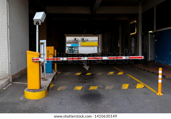 View of a car barrier gate at the entrance to\
an apartment