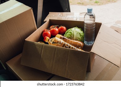 View From Car, Cardboard Box With Different Food Products. Safe Delivery Concept. Social Food Donation. Safe Contactless Home Food Delivery.