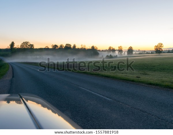 view from\
the car to the fog landscape and the\
road