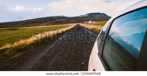 View from a car at full speed of a gravel road\
during an adventure trip.