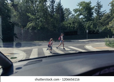 View From The Car On Children Running On Pedestrian Crossing