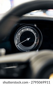 A close‑up view of a car tachometer displaying engine speed with markings from 0 to 8 and the needle resting just above 1. The crisp gauge design highlights the precision and aesthetics of modern automotive instrumentation.