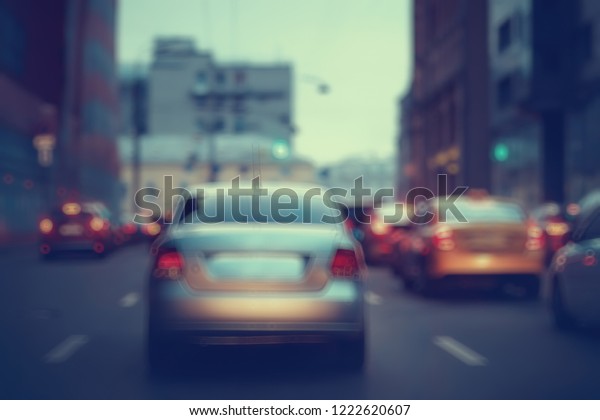 view of car in  traffic jam / rear view of the\
landscape from window in car, road with cars, lights and the legs\
of the cars  night view