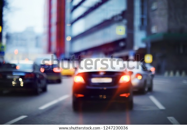 view of car in  traffic jam / rear view of the
landscape from window in car, road with cars, lights and the legs
of the cars  night view