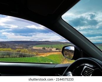 View from the car window, fields and beautiful cloudy sky