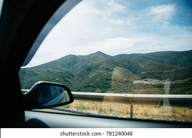 View From Car Window On Green Hills And Blue Sky, Spain