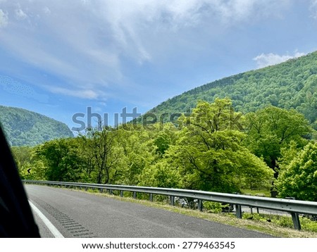 View from car window of rumble strips on the shoulder of the highway in front of the Delaware Water Gap National Recreation Area while driving on Route 80 in New Jersey in May 