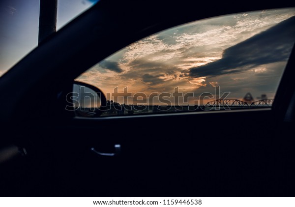 View from the car window at\
sunset