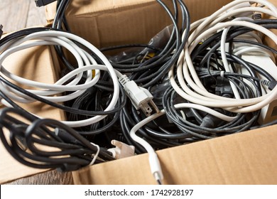 A View Of A Cardboard Box Full Of Computer And Electronic Cords.