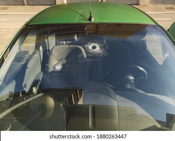 A View Of A Car's Windshield Damaged By Hail