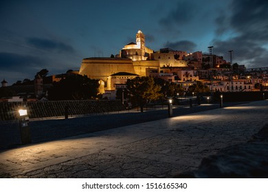 View of the Castell de Eivissa illuminated  at sunset under a perfect blue Sky in Ibiza