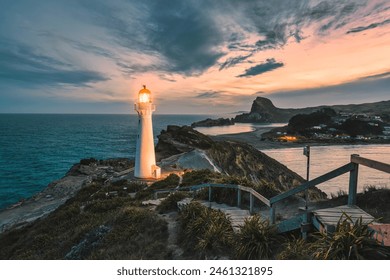 View of Castlepoint Lighthouse or Holiday Light with beam and staircase on Wairarapa coast in the evening at Wellington, New Zealand - Powered by Shutterstock