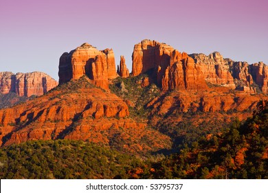 The view of Cathedral Rock in Sedona, Arizona.  The towering rock formations stand out like beacons in the dimmed landscape of the Red Rock State Park. - Powered by Shutterstock