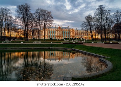 View of the Catherine Palace with night illumination and reflection in the Mirror Pond of the Catherine Park in Tsarskoye Selo in the early autumn morning. Pushkin, St. Petersburg. Russia