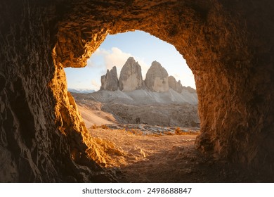 View from the cave on Tre Cime Di Lavaredo peaks in incredible orange sunset light. Three peaks of Lavaredo, Dolomite Alps, Italy, Europe. Landscape photography - Powered by Shutterstock