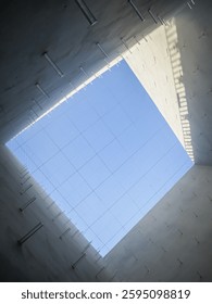 A view of the ceiling from inside the building, showcasing its architectural details and lighting.