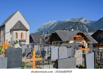 View of the cemetery and mountains in the background. Haus im Ennstal, Austria, Europe.