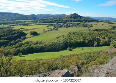 View of central bohemian uplands region in Czech republic. Old vulcanos and rural countryside. Forest hills landscape. Blue sky and fresh green. Castle ruins in Czech Republic.  - Shutterstock ID 1834220887
