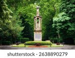 View of the central eagle column on the so-called Million Avenue of the historic Melaten Cemetery in Cologne