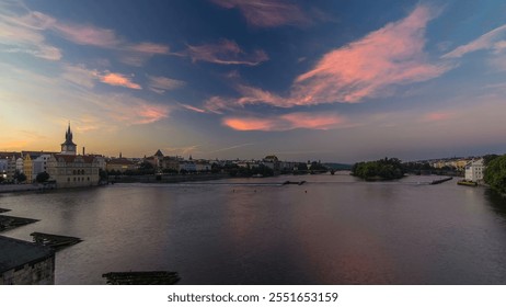 View from Charles Bridge in Prague before the sunrise night to day transition timelapse, Bohemia, Czech Republic. Cloudy colorful sky, reflection in Ltava river - Powered by Shutterstock