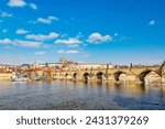 View of Charles Bridge, Prague Castle and Vltava river in Prague, Czech Republic during summer spring day.