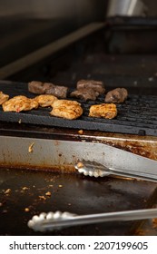 A View Of Chicken And Beef Cooking On A Restaurant Grade Stove.