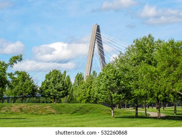 A view of the Christopher S. Bond Bridge over the Missouri River hiding behind trees