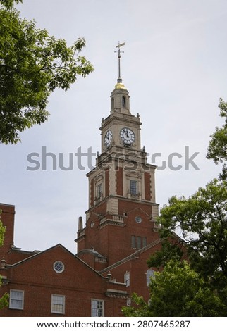 View of church clocktower with trees in the foreground