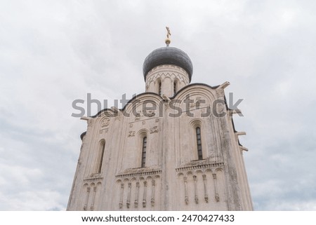 View of Church of the Intercession on the Nerl, temple in the Vladimir region of Russia, built in the 12th century. Relief with David the psalmist, lions and griffins on the facade of Church.