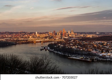 A View Of The Cincinnati, Ohio Skyline And The Ohio River At Sunset On A Cold Winter Evening.