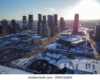 View of city centre blanketed in snow, including city hall, the Living Arts Centre and several residential condominium towers in downtown Mississauga, Ontario, Canada. Shot from a drone.