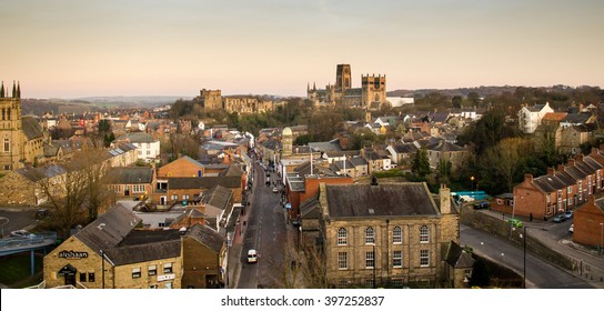 The view of the city of Durham, including the castle and cathedral, from the railway viaduct at sunset.