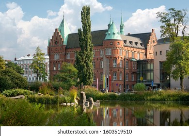 View of the city library in Malmo, Sweden. View with reflection of Malmo City Library, across the Lilla dammen lake.