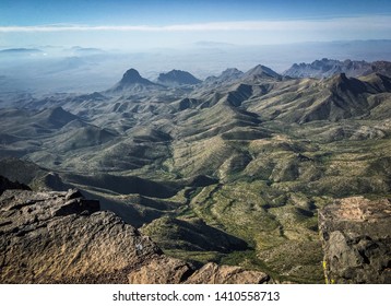 View From The Cliff Edge On The South Rim Trail In The Chisos Mountains, Big Bend National Park, Texas. Distant Peaks Dusted With Green Vegetation.