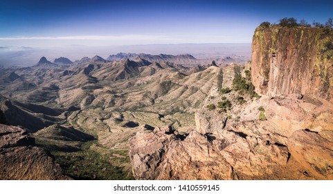 View From The Cliff Edge On The South Rim Trail In The Chisos Mountains, Big Bend National Park, Texas. Distant Peaks Dusted With Green Vegetation.