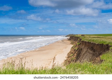 A view of a cliff highlighting coastal erosion at Happisburgh in North Norfolk, UK - Powered by Shutterstock