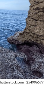 view of a cliffside by the ocean 
