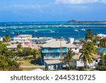 View of Clifton and Clifton harbour, Union Island, with Palm Island in the distance, The Grenadines, St. Vincent and The Grenadines, West Indies, Caribbean, Central America