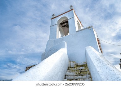 The view of Clock tower, Torre do Relogio built in one of the towers of the town walls on the right bank of Guadiana. Mertola. Portugal