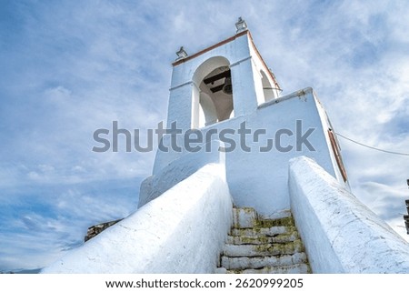The view of Clock tower, Torre do Relogio built in one of the towers of the town walls on the right bank of Guadiana. Mertola. Portugal